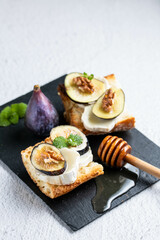 Toasted fresh bruschetta with goat cheese and figs and honey. Copy Space.