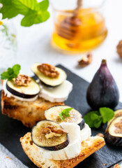 Toasted fresh bruschetta with goat cheese and figs and honey. Copy Space.
