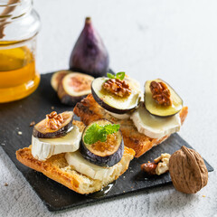 Toasted fresh bruschetta with goat cheese and figs and honey. Copy Space.