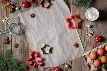 christmas background for baking gingerbread cookies with cutters and spices. Empty cooking paper for holiday recipe.