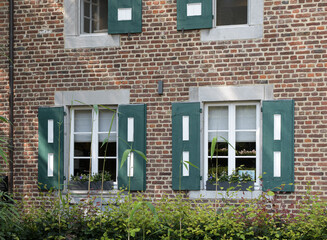 Fototapeta na wymiar Hasselt, Limburg, Belgium 16-07-2021. Fragment of an old building at the entrance to the public park - shutters, windows