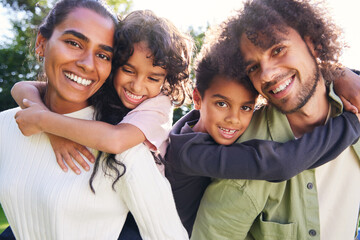 Portrait of family smiling towards camera