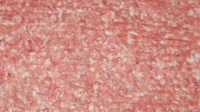 TOP VIEW: A fork in a cook hand is moving on a fresh forcemeat