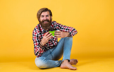 drinks for friends. good morning. morning vibes at home. concept of inspiration. hipster man drink coffee. handsome bearded man holding a white cup. mug with beverage. drinking tea or coffee