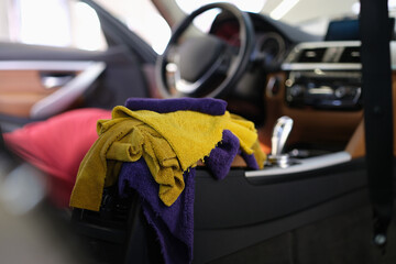 Multicolored microfiber rags lying in car interior closeup