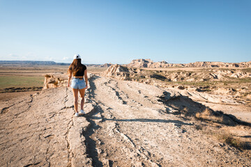 Fototapeta premium Young caucasian woman at Bardenas Reales, Navarra, Basque Country.
