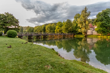 Fototapeta premium Otocec Castle on the Krka River at sunset with a beautiful reflection in rural Slovenia 