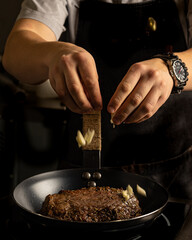 a man preparing roast beef in a frying pan