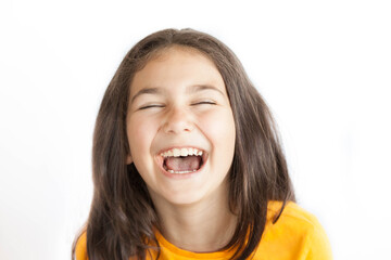 Portrait of happy smiling kid girl in yellow T-shirt isolated on white background