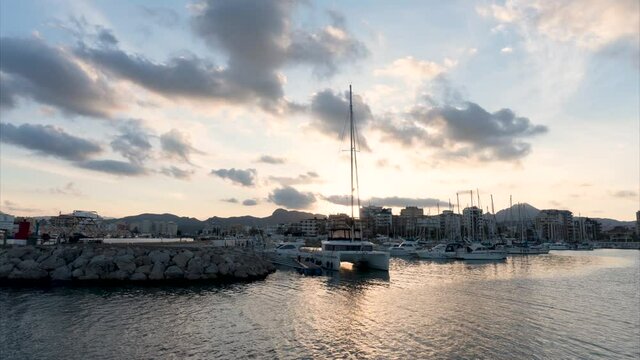 Sunset time lapse video in the port, with a cloudy sky.