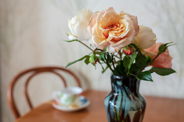 Photography to theme beautiful bouquet roses in vase on wooden table
