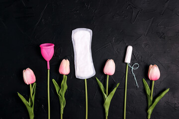 Different types of feminine hygiene products. Tampons, menstrual cup and sanitary pads like tulip...