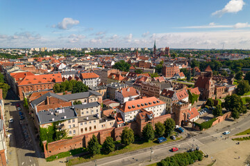 Naklejka premium Torun, a Polish city during the day. A sunny and slightly cloudy day in Toruń on the Vistula River.