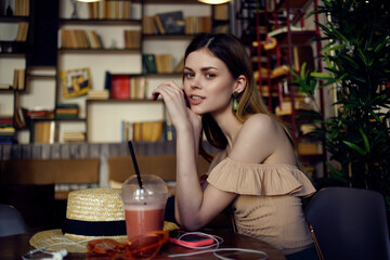 pretty woman reading a book in a cafe communication
