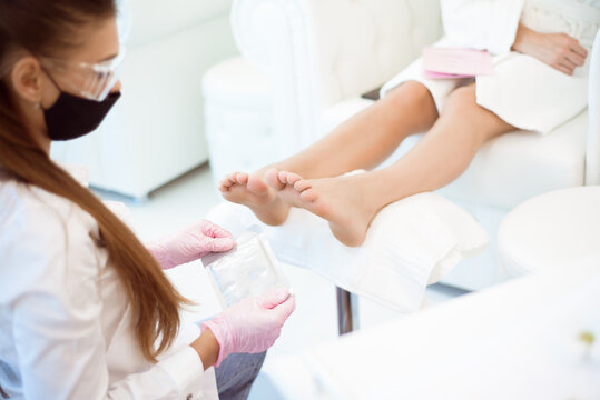 Woman feet receiving pedicure in a Day Spa
