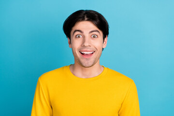 Photo of young excited man happy positive smile amazed shocked news sale isolated over blue color background