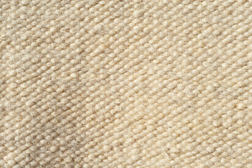 Sheep wool fabric texture. Knitted wool close up.