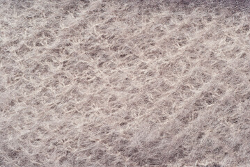 Goat wool fabric. Mohair close up. Beige knitted fabric.