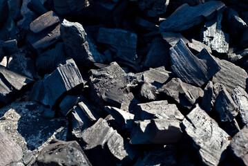 Coal from burned firewood. Heat in the grill. Coal texture close up.