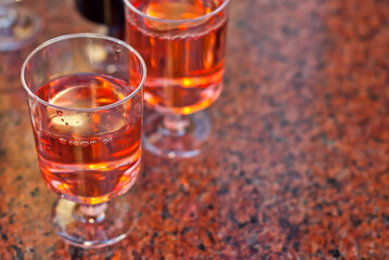 Plastic glasses with wine close up. Different types of wine on a marble table.