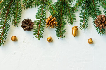 Christmas or New Year's background with decorative elements made by soy hands. golden cones, nuts, acorns. a copy of the space.