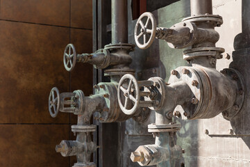 Old rusty valves of industrial oven from steam revolution times with pipes all in steampunk climate