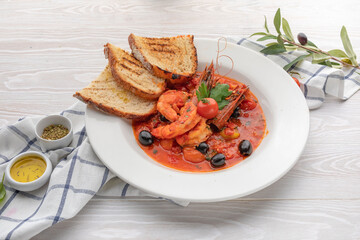 tomato soup with vegetables shrimp olives and croutons