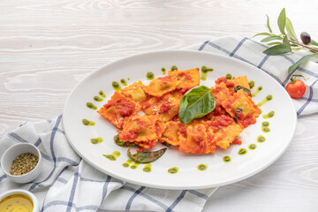 ravioli in tomato sauce with spinach leaf