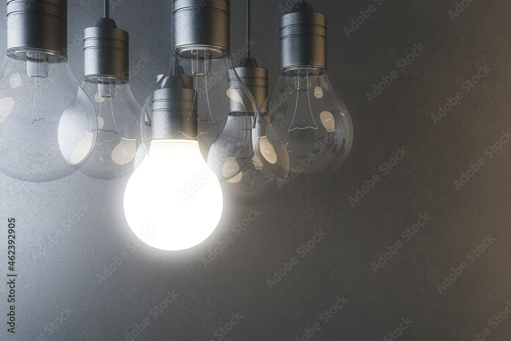 Aufkleber glowing light bulb on blurry concrete wall background. idea, innovation, solution and invention conc