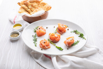 fresh delicious lightly salted salmon is decoratively served on a white plate dish from the restaurant