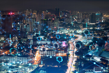 Information flow hologram, night panorama city view of Kuala Lumpur. KL is the largest technological center in Malaysia, Asia. The concept of programming science. Double exposure.