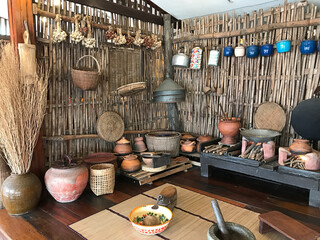 Exhibition of traditional Thai kitchen utensils at Amphawa Floating Market in Thailand.