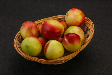Sweet small nectarines in the basket