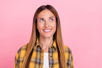 Fototapeta premium Photo of dreamy young happy woman smile good mood look empty space isolated on pastel pink color background