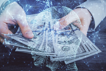 Multi exposure of brain drawing hologram and us dollars bills and man hands. Ai invest concept