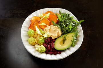 Delicious Buddha bowl with vegetables and hummus