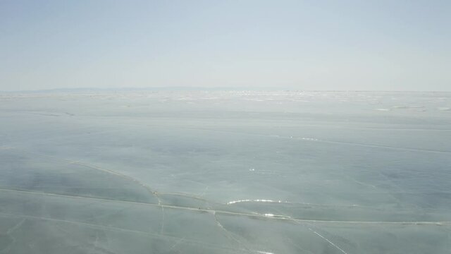 winter landscape flight over the ice of Lake Baikal, aerial video filming