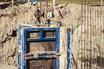 Monolithic foundation formwork. Forms vertical formwork structures for the basement of a residential building. Monolithic concrete foundation. Support foundation. Home construction.