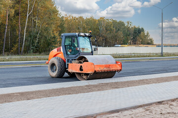 Heavy-duty vibratory roller for asphalt paving. Road construction. Construction of roads and urban transport communications. Heavy machinery.