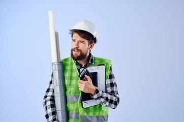 male builder with documents and drawings blueprints blue background