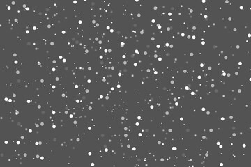 Abstract winter background from snowflakes blown away by the wind on  gray backdrop. White dust. Christmas background. Magic shining white dust. Fantastic shimmer effect
