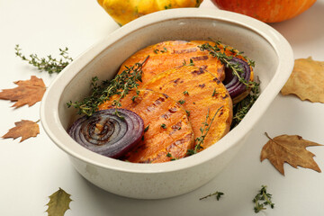 Autumn concept with baked pumpkin on white background