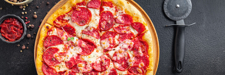Pizza salami fast food pepperoni sausage, cheese, tomato sauce, dough fresh meal snack on the table copy space food background rustic 