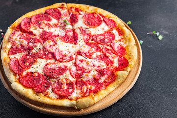 Pizza salami fast food pepperoni sausage, cheese, tomato sauce, dough fresh meal snack on the table copy space food background rustic 