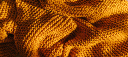 Orange autumn knitting wool texture background.