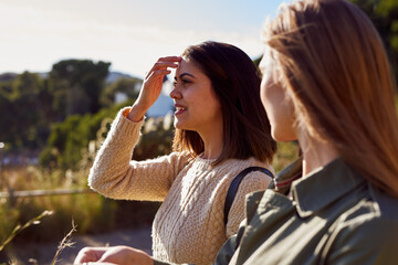 Two female friends walking together outdoors