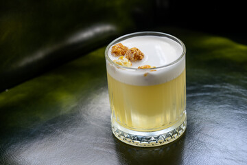 alcoholic cocktail with popcorn on a green background close-up
