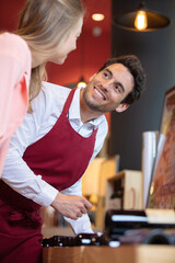 vendor tending to female customer in liquor store