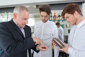 manager showing coffee beans to students