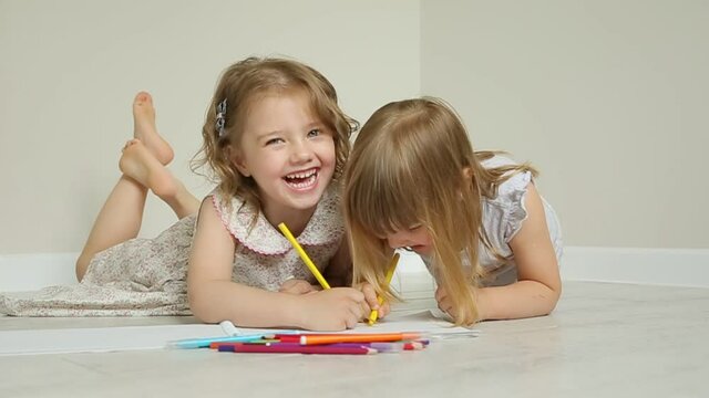 children girls draw houses on the floor